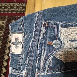 Blue Distressed Jeans with Decorative Stitching